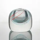 Glass sculpture, clear with red, blue, and white filigree, features a dome-shaped upper section and rectangular base with swirling internal patterns.