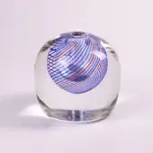 Glass orb with blue and red filigree, spherical shape, clear glass base, dynamic spiral design, transparent, soft lighting.