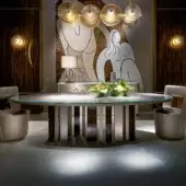 Distinctive Sicis Koro table with sleek glass top and dynamic circular metal and ebony base crafted in Italy