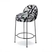 Bar stool, black and white patterned fabric, curved seat and back with angled matte black metal legs and circular footrest.