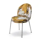 Accent chair, amapolas mustard upholstery, mosaic floral pattern with curved oval backrest and polished metal tapered legs.