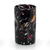 Spotted black glass vessel with irregular red, orange, yellow, blue & white spots, textured surface, purple & white rim, studio shot.