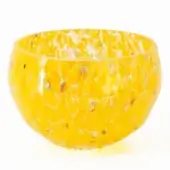 Spotted yellow bowl, translucent material, rounded shape with white and dark speckles against a plain white backdrop.