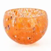 Orange glass bowl with speckled pattern, rounded shape, and flared rim displayed on a white background in studio lighting.