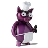 Purple pig figurine, glossy ceramic, with white chef’s hat and apron, black eyes, raised hand, studio product shot on white background.