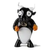 Glass bull sculpture, black and white, rounded form with amber translucent forearms and gold nose ring, studio lighting.