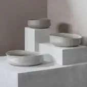 Distinguished Rina Menardi Cenote vessels crafted from baked clay with a subtly textured, minimalist form in a light grey tone