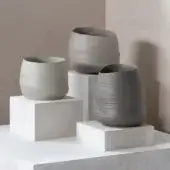 Exceptional Rina Menardi Cenote Alto vessel crafted in baked clay with earthy grey-beige and taupe tones plus a subtly textured matte finish