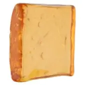 Amber Yncanto block, translucent honey-yellow, irregular rectangular shape with mottled darker border and subtle internal inclusions.