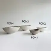 Ceramic bowls, off-white, arranged in a row displaying varied sizes and swirling textures with organic, asymmetrical forms against a gray backdrop.