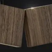 Walnut lighting panels angled against black, displaying vertical wood grain and a matte finish with diffused light highlighting texture.