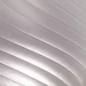 Undulating silver-grey stripes create a smooth, matte texture with subtle light variations and a dynamic, warped pattern against a light grey background.