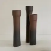 Exclusive Rina Menardi Steli vase crafted in baked clay with a gradient transitioning from reddish-brown to charcoal gray