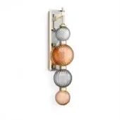 Wall sconce, brass and glass, featuring four ribbed spherical globes in smoky gray and amber tones, mounted on a white wall.