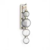 Wall sconce with three spiraled glass globes and brushed brass fittings, featuring a rectangular mirrored backplate for light reflection.