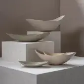 Distinguished Rina Menardi Barchette centerpiece crafted from baked clay with undulating curves and matte finish in beige and pale olive green