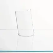 Glass vase, transparent cylindrical shape, on white reflective surface, studio lighting, simple composition.