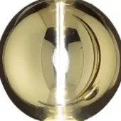 Gold glass sphere with polished finish reflecting bright white light and curved golden base in a studio setting.