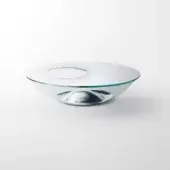 Glass coffee table, silver tone, asymmetrical bowl shape with central cutout and curved base, polished reflective surface.