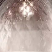 Fume glass lampshade with diamond texture, smoky gray to pink gradient, and central lightbulb emitting diffused glow.