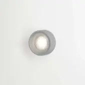 Berlin out wall light, matt aluminum, cylindrical fixture with diamond-patterned diffuser and warm LED glow against off-white wall.