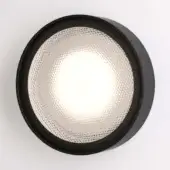 Round wall light, matte black finish, with textured translucent glass and diamond pattern diffusion, studio product shot.