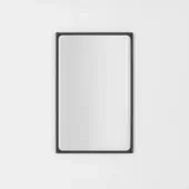Rectangular mirror with black frame, rounded inner edge, and matte finish, centered on a white wall reflecting muted gray ambient light.