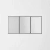 Folding mirror, gray metal frame, three rectangular panels, minimalist design, against a light gray wall, modern geometric form.