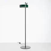 Floor lamp, matte black metal, slender cylindrical stem with deep green shade and chrome accent band, adjustable arm, modern design.