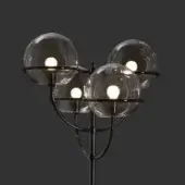 Mid-century floor lamp with black metal frame and four smoky gray glass globes, asymmetrical arched design.