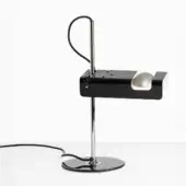 Black spider desk lamp with chrome stem, rectangular base, and pearl-white spherical reflector in studio lighting.