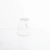 Blown glass vessel, transparent with crack, irregular organic shape on white reflective surface, diffused studio lighting.
