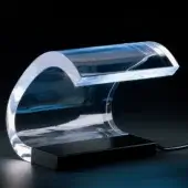 Acrylic tanning bed, clear acrylic, curved enclosure with interior white light and black rectangular base.