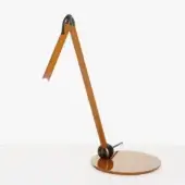 Calamaio desk lamp in mustard yellow with dark metal base, slender arm, and rectangular head emitting focused light, minimalist design.