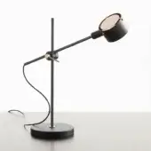 Black desk lamp with cylindrical stem, circular base, flexible arm, conical shade, and brass accent rings, matte finish.