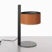 Table lamp, matte black metal with brown leather shade, featuring a slender stem and horizontal bar on a gray surface.