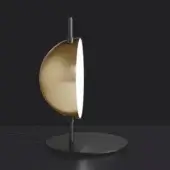 Table lamp, anodic brass and black, featuring a large half-spherical lampshade with a slender stem and circular base, emitting diffused light.