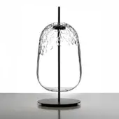 Galuchat table transparent, glass tabletop, elongated teardrop shape, textured surface, matte black metal support, minimalist design.