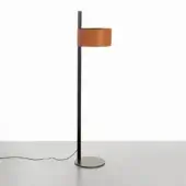 Floor lamp, matte black metal with rectangular brown leather shade, slender cylindrical stem, neutral studio lighting, gray surface.