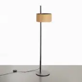 Floor lamp, matte black metal with sand leather shade, featuring a slender stem, circular base, and cylindrical lampshade.