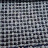 Textile sample with checkerboard pattern in sage green, indigo, and beige; simple over-under weave creates a matte, textured surface.