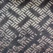 Textile sample with dark blue and off-white chevron weave, featuring a textured surface and muted navy-toned geometric pattern.