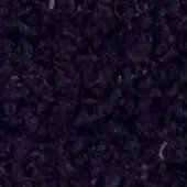 Shredded purple fiber texture, densely packed with irregular, fibrous strands and subtle tonal variations in a studio setting.
