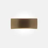 Wall sconce, anodic bronze, curved geometric design with diffused light and brushed metallic finish against a light gray backdrop.