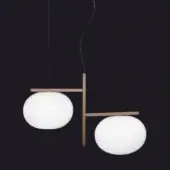Pendant light, bronze and opal glass, features two spherical shades connected by a cross-shaped metal frame with black suspension cables.