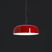 Scarlet red pendant lamp with a glossy dome shape, silver cable, and white interior, studio lit against a dark gray backdrop.