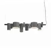 Pendant lamp, lacquered grey, with multiple cylindrical and conical shades extending from a horizontal metal bar in a studio setting.