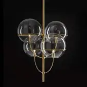 Chandelier, satin gold finish, with four spherical glass globes and exposed Edison bulbs suspended from a curved brass arm.