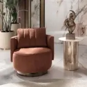 Lavish DV Home Collection Beverly lounge chair upholstered in matte terracotta fabric with a shining stainless steel swivel base