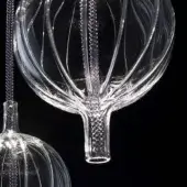 Glass pendant lights, clear Hydra Lambda design, feature bulbous tops with radial starburst patterns and hand-blown bubble inclusions.